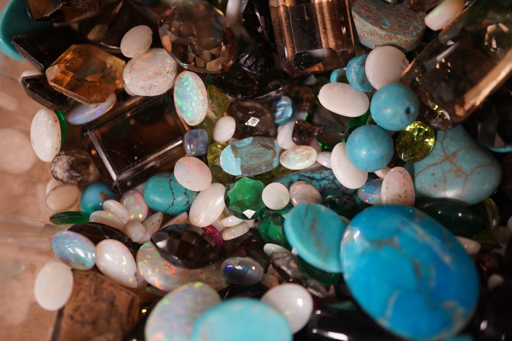 A large quantity of assorted unmounted cut and cabochon gemstones etc, including opal, quartz and turquoise. Condition - poor to fair to good